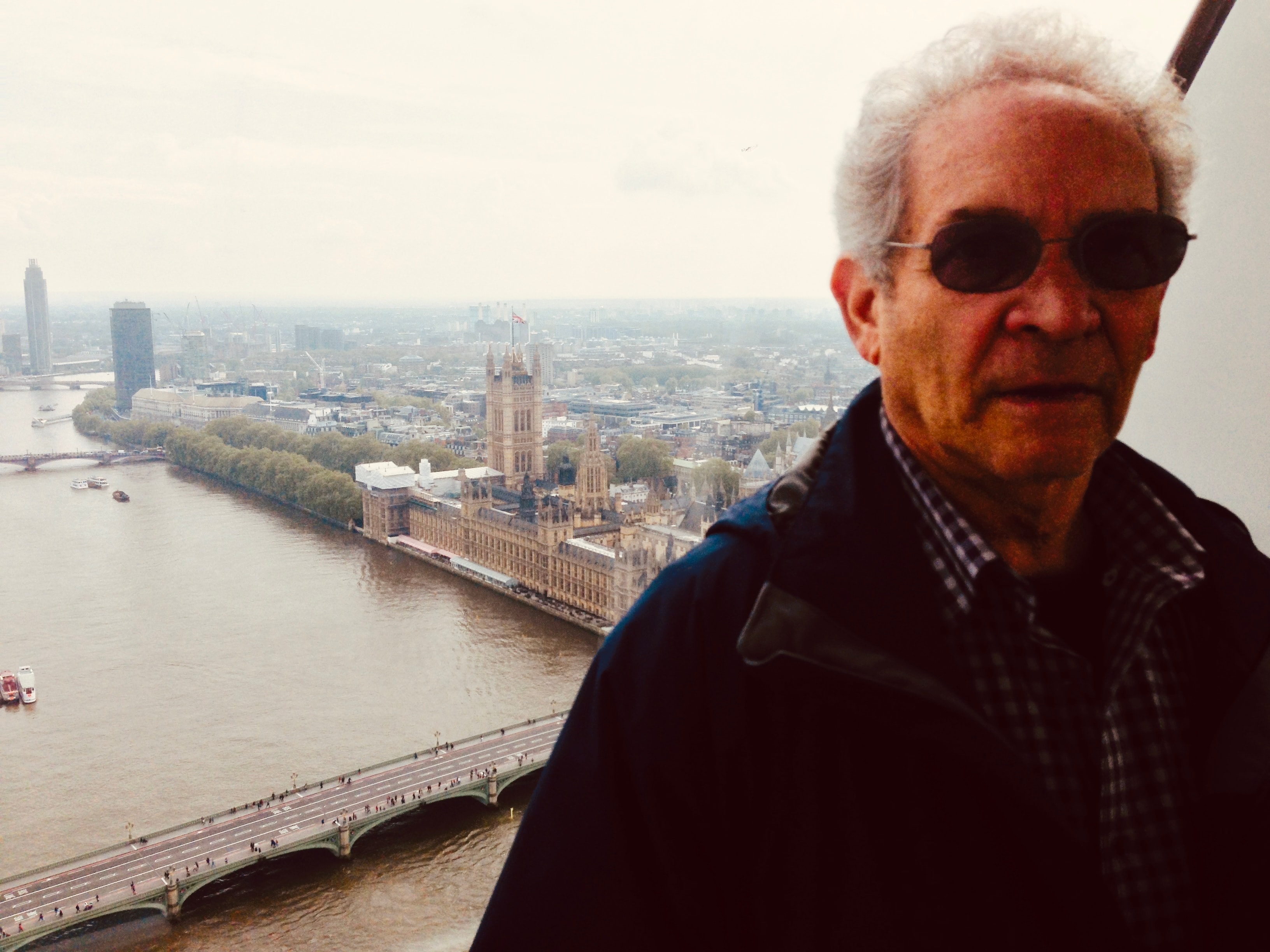 Barry L. Becker doing research in London, England, with the Houses of Parliament and River Thames in the background